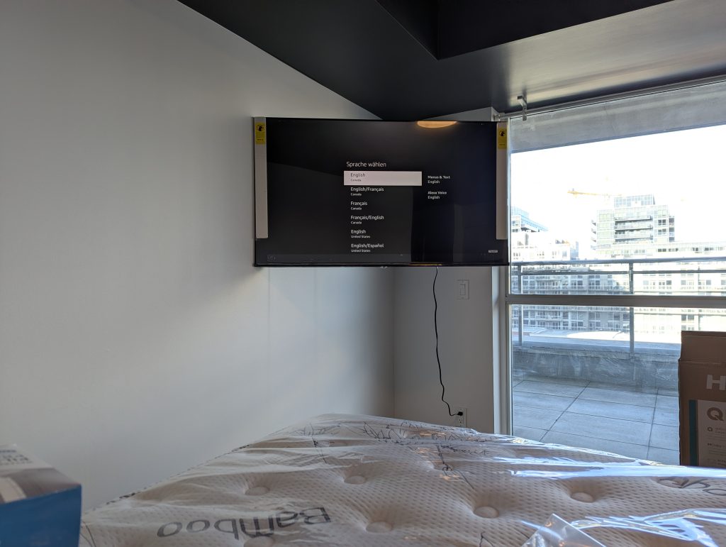 Wall mounted TV on articulating arm concrete wall